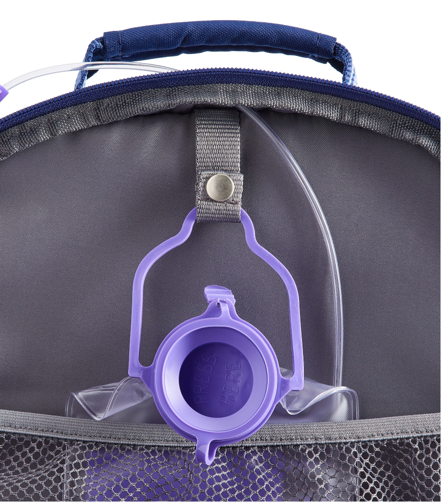 Image shows close up of the Pottery Barn Kids Mackenzie Adaptive Backpack pocket with a hanging feeding bag attached.