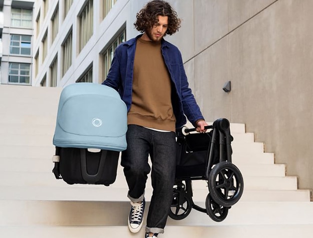 Man walking down stairs with stroller