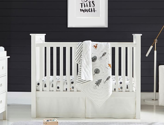 Crib with blanket draped over side