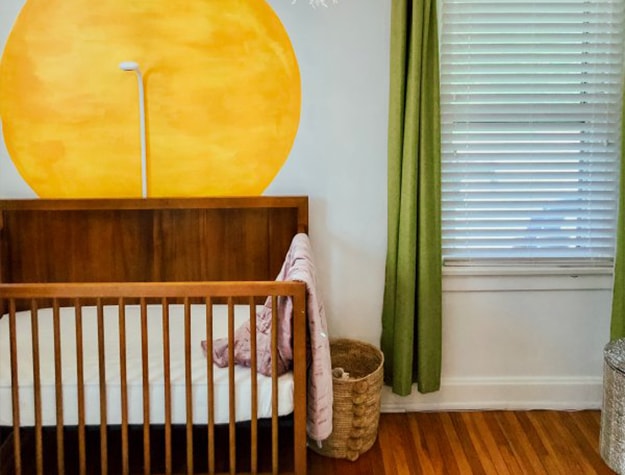 Wooden crib with wall mounted baby monitor 