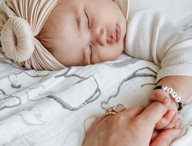 Mom and baby holding hands