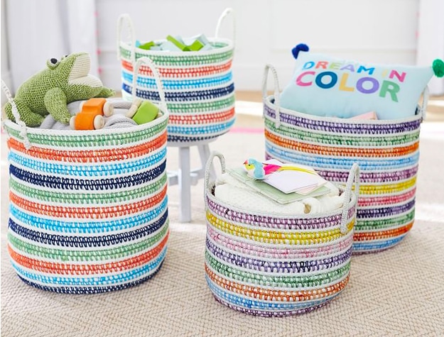 Rainbow baskets holding toys and baby supplies