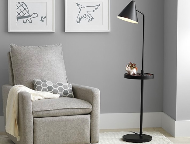 Gray nursery with rocker and black metal floor lamp