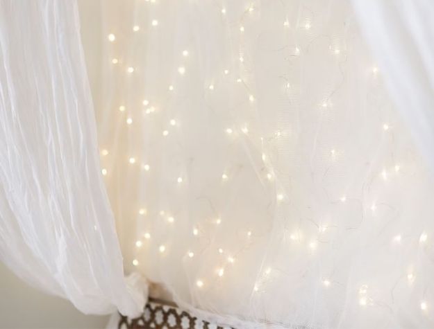fairy light canopy above bed