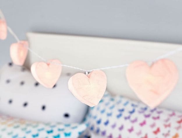 paper mache heart string lights above bed