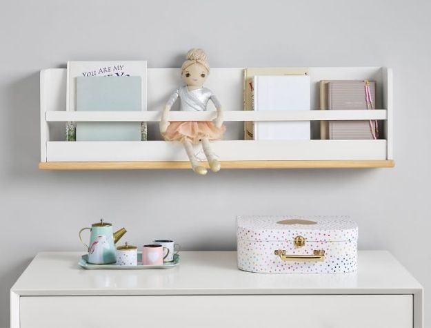 nursery bookshelf with books and doll
