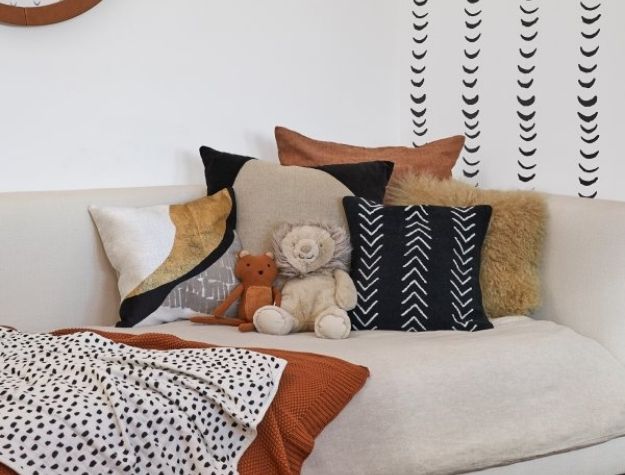 plush toys and pillows on couch