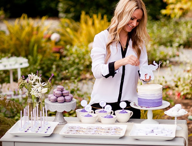 Woman putting up cupcake decorations