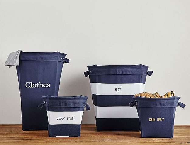 Navy canvas storage hampers labeled with baby supplies