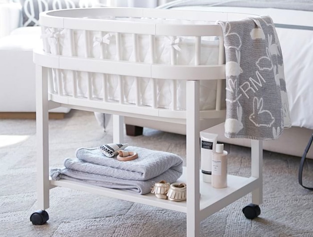 White bassinet with baby supplies