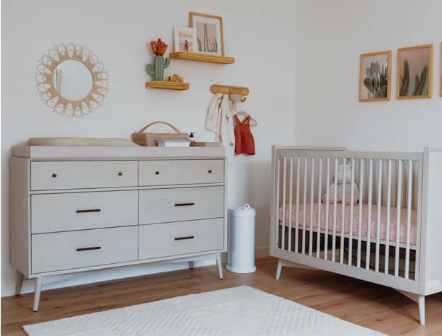 White dresser and crib in nursery