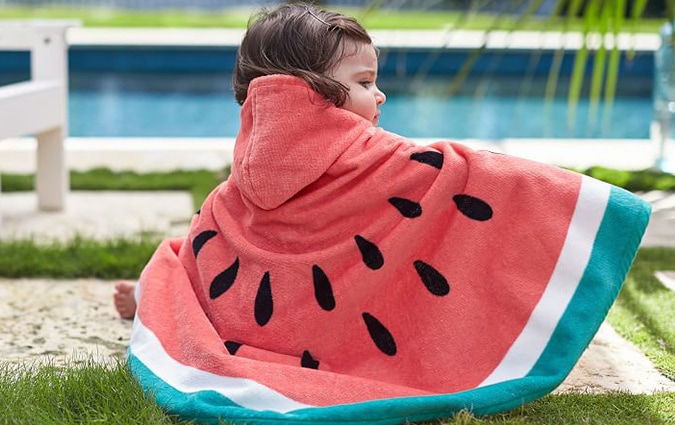 Baby outside wrapped in watermelon beach wrap