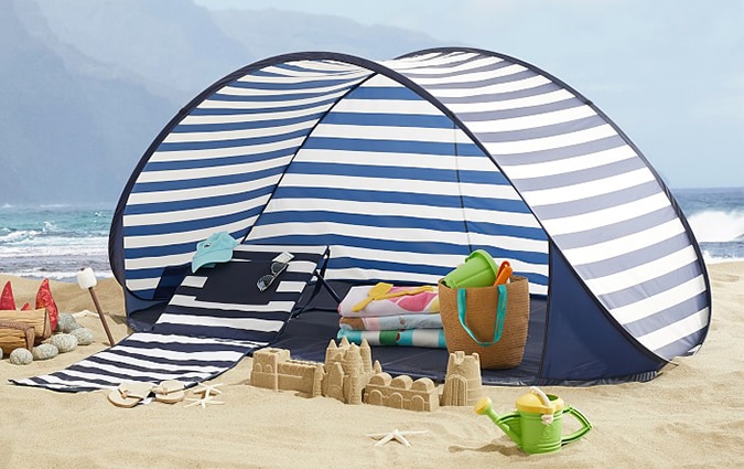 Striped blue and white sunshade at the beach 
