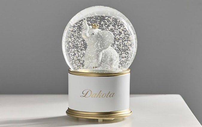 Elephant snow globe with gold trim and Dakota name printed on the side