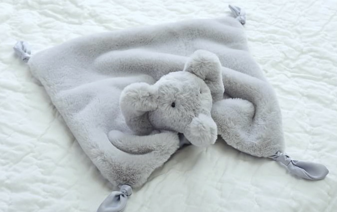 Light gray elephant blanket over white background