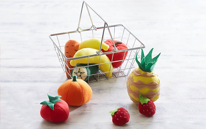 Mini grocery basket with cloth made fruit on table