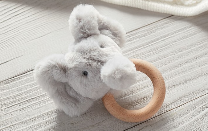 Stuffed elephant on wooden ring rattle