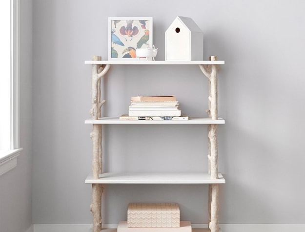 Wooden bookcase with tree branch legs.
