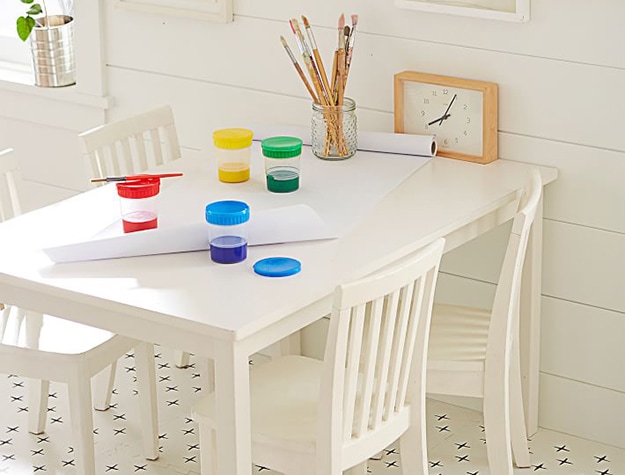 White play table with paints and brushes