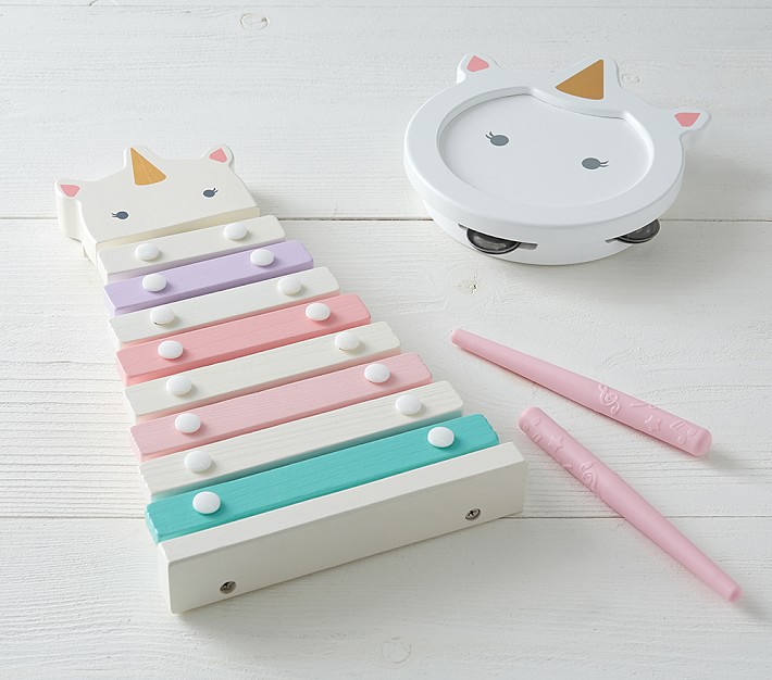 unicorn-themed toy xylophone and tambourine on wooden surface