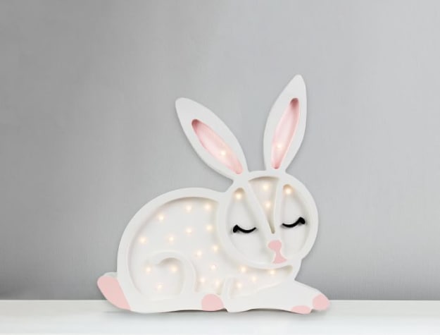 white and pink sleepy bunny-themed lamp decorated with several small lights