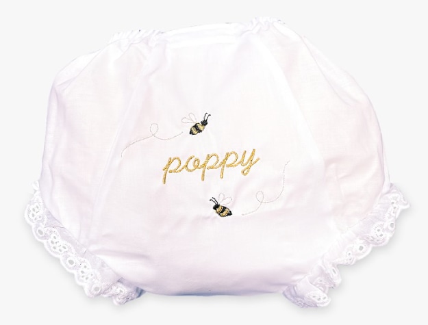 light pink diaper cover decorated with bees and the name “Poppy”