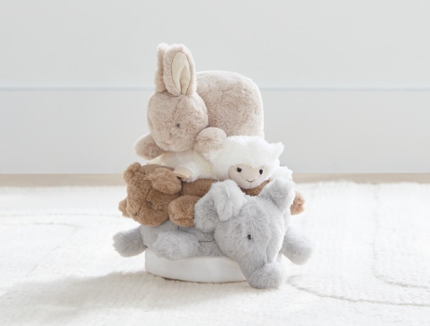 vertical stack of four plush animals on the floor