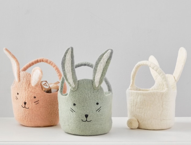 three bunny-themed felted Easter buckets filled with toys
