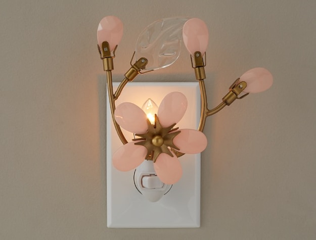 flower nightlight made of brass, light pink glass and clear glass plugged into wall