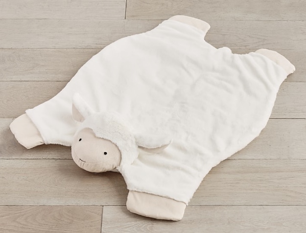 lamb-themed playmat with elevated plush head spread out on the floor