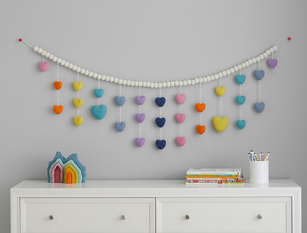 Felted wool multi-heart garland hanging over dresser.