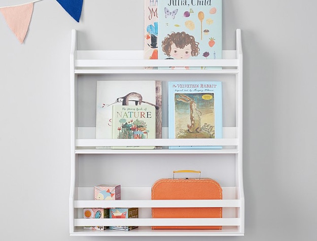 Collector's 3 tier book rack with kids books and blocks on shelf.