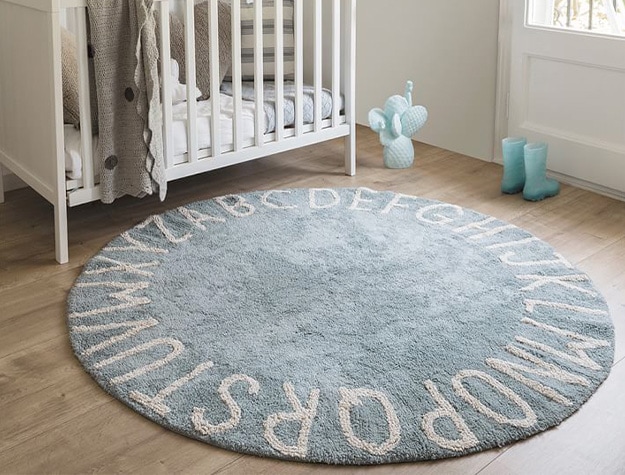 Blue Lorena Canals washable ABC rug in a nursery.