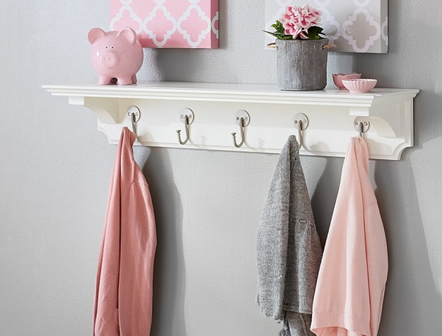 White Classic Hook Shelf with pink and gray baby clothes hanging on hooks.