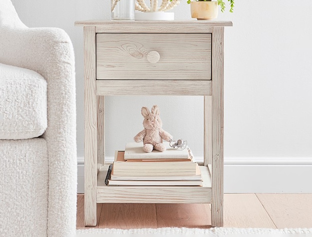 Weathered white Kendall Nightstand with books and stuffed animal.