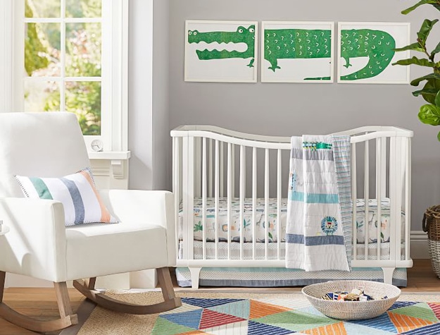 Simply white Dawson Scoop Convertible Crib against gray wall with alligator wall art.