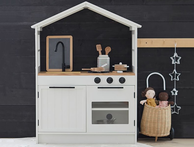 Wooden kitchen toys including sink, pans, pots and spatula.