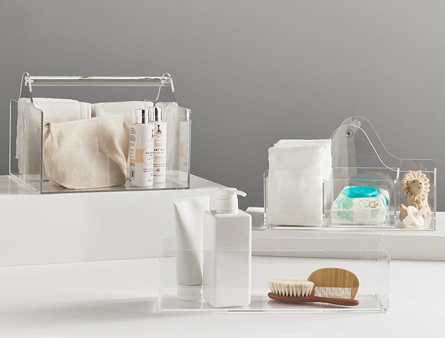 Clear acrylic storage containers with changing table essentials.