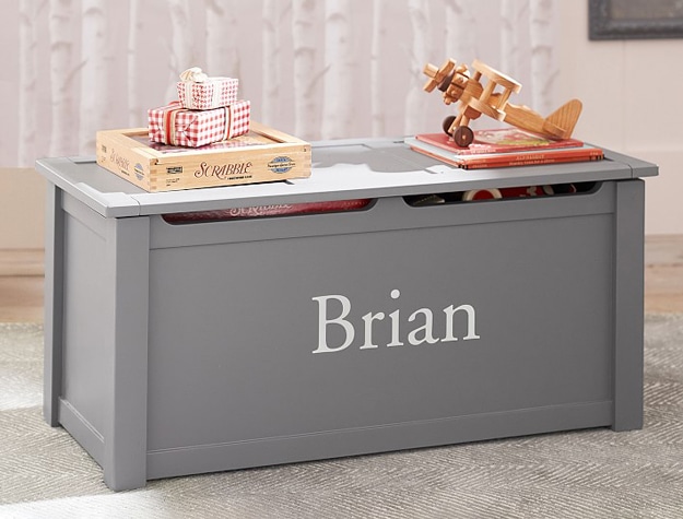 Gray toy storage box personalized with child’s name.