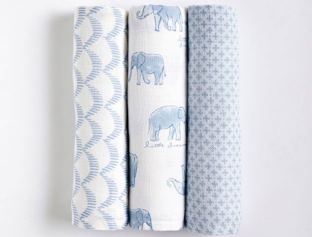Three blue patterned receiving blankets in the Jack Nautical Organic Muslin Swaddle Set.
