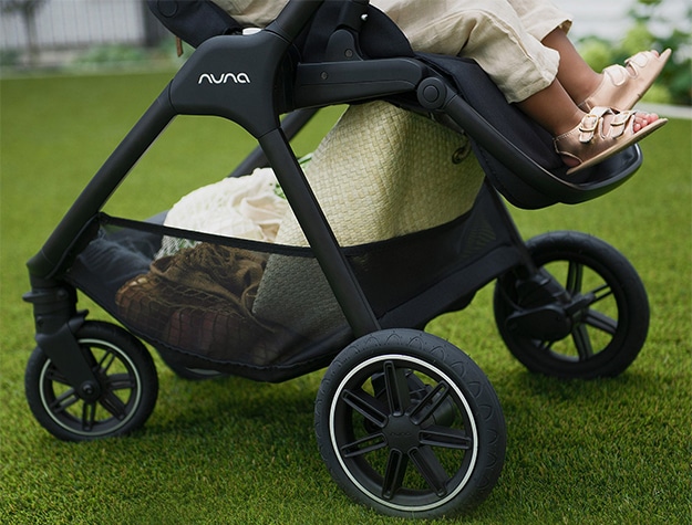Nuna TRIV™ Next Stroller wheels on turf grass.