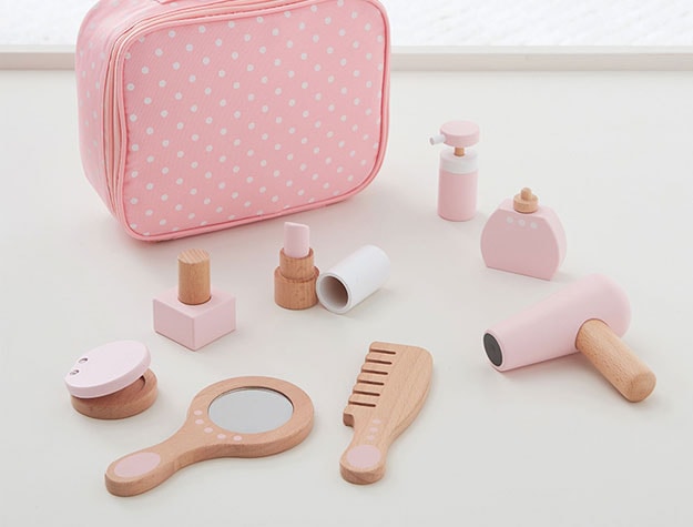 Pink wooden salon kit with a mirror, comb and hairdryer.