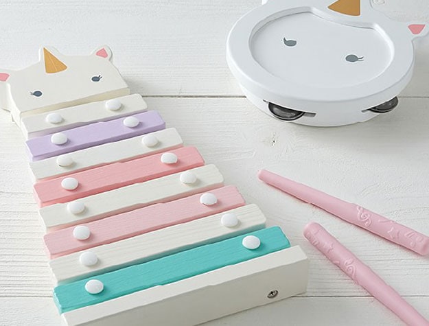 A colorful toy xylophone and tambourine with unicorn details.