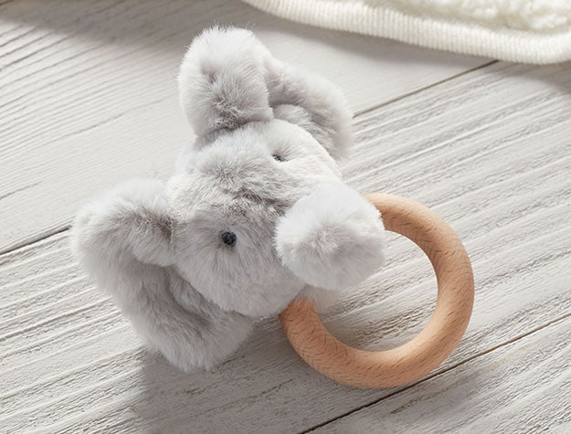 Furry elephant rattle with a tan handle.