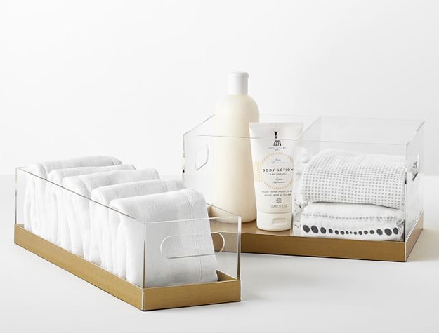 Clear nursery organizers containing lotion bottles and washcloths.