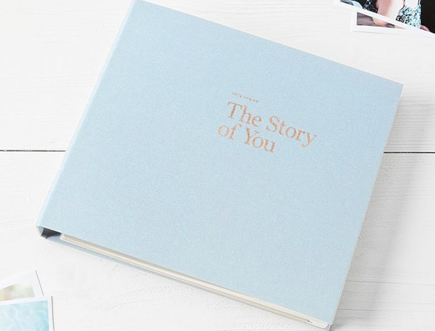 Light blue story scrapbook embossed in gold with the title The Story of You on the cover.