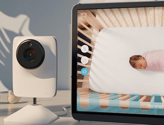 Baby monitor showing baby sleeping in a crib on a tablet screen.