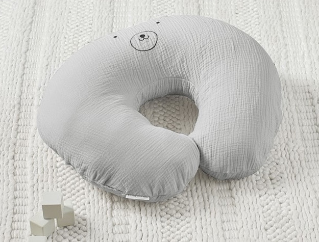 Gray newborn lounger with smiling bear’s eyes, mouth and nose at the top.