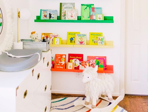 Colorful wall shelves with toy rocker and changing table