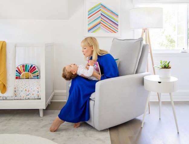 Mom holding baby in nursery